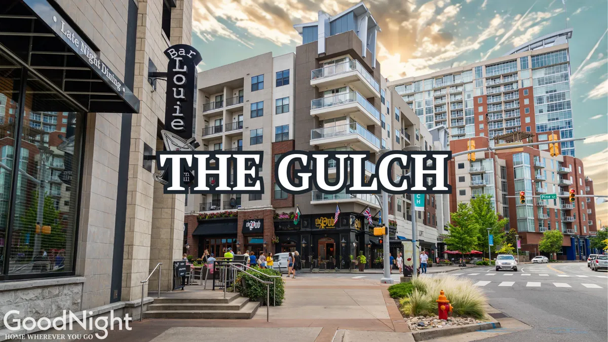 An energetic urban street scene with the Bar Louie sign, modern apartment buildings, outdoor restaurants, and pedestrians enjoying the lively city environment. The image captures vibrant city life, walkability, and the local food and social scene.